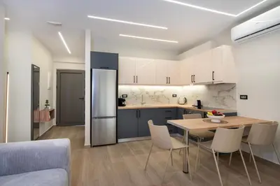 a kitchen and dining room with a table and chairs at Kalopsia Luxury Apartment Near Chania in Chania Town