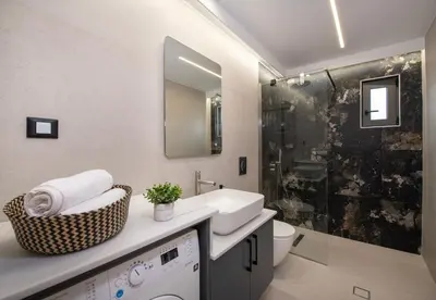 a bathroom with a sink and a toilet and a shower at Kalopsia Luxury Apartment Near Chania in Chania Town
