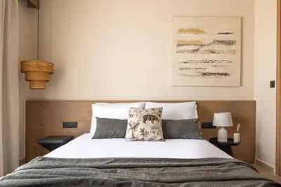 a bedroom with a bed with white sheets and pillows at Yemaya Sea View Villa in Chania Town