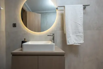a bathroom with a white sink and a mirror at Basiliko in Kalidhónia