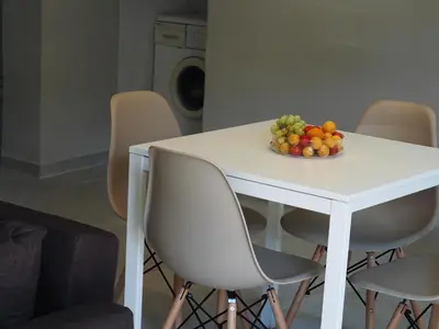 a white table with a bowl of fruit on it at Rodi Apartment in Kolymvari