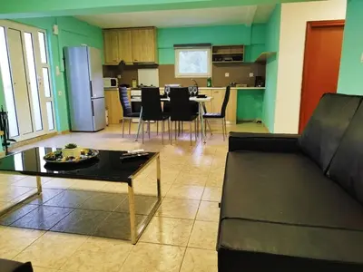 a living room with a couch and a table at SleepiLi in Vrísai