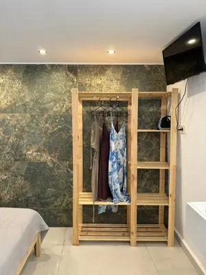 a room with a wooden closet with a clothes rack at Kasteli Apartment in Kissamos