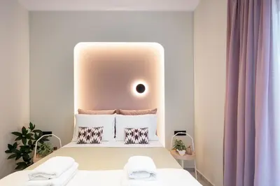a small bedroom with a bed with a headboard at Centrale Apartment Chania in Chania Town