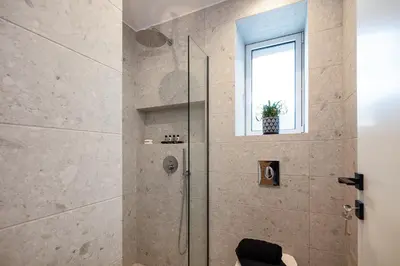 a bathroom with a shower with a window at Centrale Apartment Chania in Chania Town