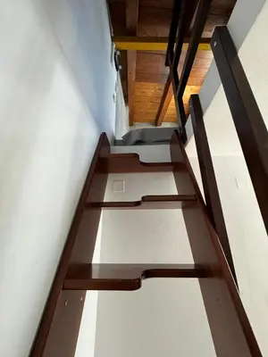 a stair case in a room with wooden ceilings at Kasteli loft apartment in Kissamos