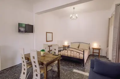 a living room with a couch a table and a bed at Koumbes home in Chania Town