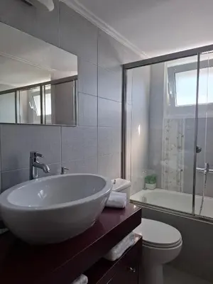 a bathroom with a white sink and a toilet at UPapartment in Chania Town