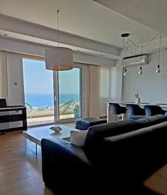 a living room with a couch and a table at UPapartment in Chania Town