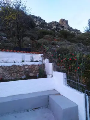 a group of stairs with flowers on a hill at Agnanti in AsfendhilÃ©s