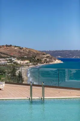 a swimming pool with a view of the ocean at Panorama Seaview Village at Kalyves in Kalyves
