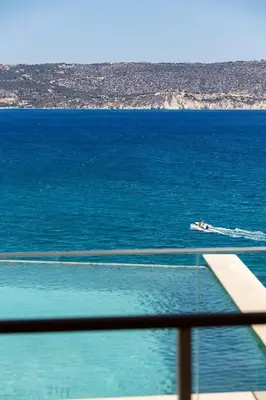 a boat in the water near the ocean at Panorama Seaview Village at Kalyves in Kalyves
