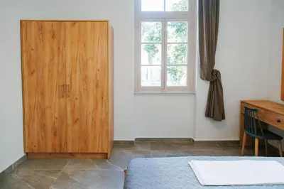 a bedroom with a wooden door and a desk at Be Crete - Villa Erofili in Chania Town