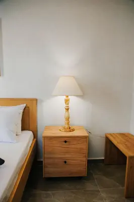 a lamp on a night stand next to a bed at Be Crete - Villa Erofili in Chania Town