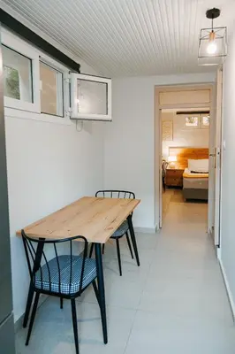 a table and chairs in a room with a bedroom at Be Crete - Villa Erofili in Chania Town