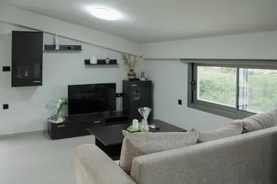 a living room with a couch and a television at Welcome U in Gerani Chanion