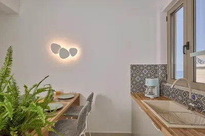 a kitchen with a table with chairs and a sink at Mantis' House in Chania Town