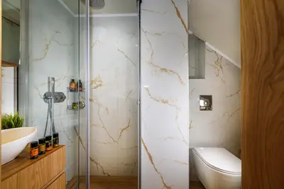 a bathroom with a shower with a toilet and a sink at Nicolas Urban Luxury Living in Souda