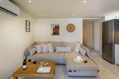 a living room with a couch and a table at Nicolas Urban Luxury Living in Souda