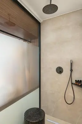 a shower with a glass door in a bathroom at Elia Sea Suites in Chania Town