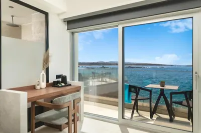 a home office with a desk and a view of the ocean at Elia Sea Suites in Chania Town