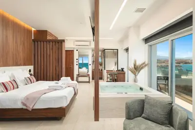 a bedroom with a bed and a bath tub at Elia Sea Suites in Chania Town