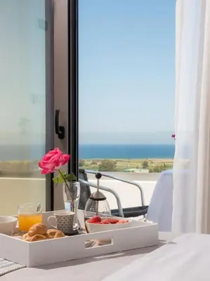 a tray of food on a table with a view of the ocean at Panoramic view villa - Selita in Tavronitis