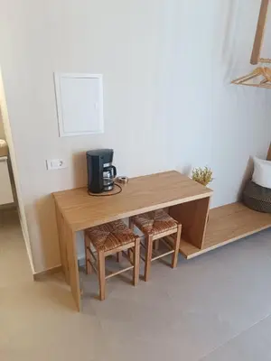 a wooden table with a coffee maker on top of it at Talos in Sougia