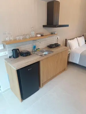 a kitchen with a sink and a bed in a room at Talos in Sougia