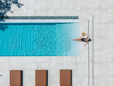 a woman is swimming in a swimming pool at Nuera Villas in Chania Town