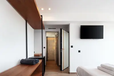 a bedroom with a bed and a tv on a wall at Nuera Villas in Chania Town