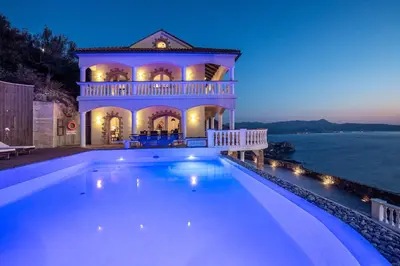 a large swimming pool in front of a house at Villa Sun Rock - Ravdoucha in Kolymvari