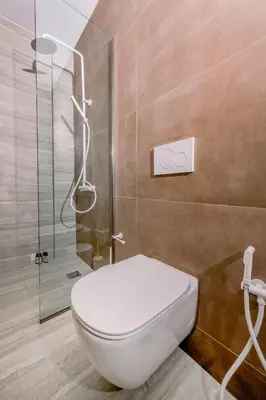 a bathroom with a toilet and a glass shower at Nidra Studio with private pool in Chania Town
