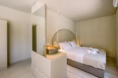 a bedroom with a bed with a mirror on it at Nidra Studio with private pool in Chania Town