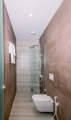 a bathroom with a toilet and a glass shower at Nidra Studio with private pool in Chania Town