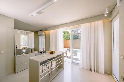 a kitchen with a counter and a large window at Nidra Studio with private pool in Chania Town