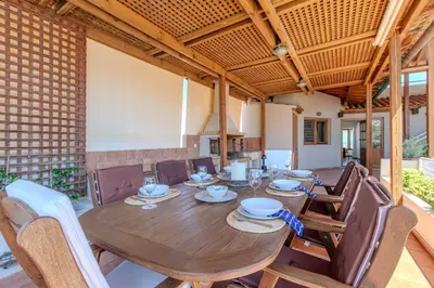 a dining room with a wooden table and chairs at Platanias Memories Apartment in Plataniás