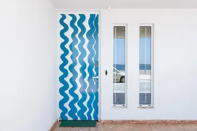 a white door with a blue and white stripe on it at 8 Min walk to Harbour in Chania Town