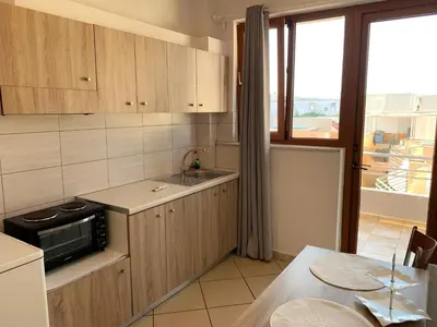 a kitchen with a sink and a microwave at Platanias Memories Studio 5 in Plataniás