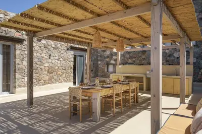 an outdoor kitchen with a table and chairs at Newly Renovated villa Artemis with Private Pool just 20min from Elafonissi in Livadia