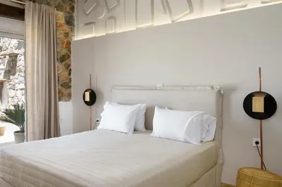 a bedroom with a white bed with white pillows at Newly Renovated villa Artemis with Private Pool just 20min from Elafonissi in Livadia