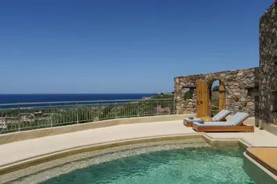 a pool with chaise lounge chairs and a house at Newly Renovated villa Artemis with Private Pool just 20min from Elafonissi in Livadia