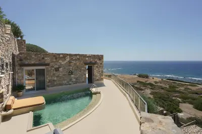 a house with a swimming pool next to the ocean at Newly Renovated villa Artemis with Private Pool just 20min from Elafonissi in Livadia
