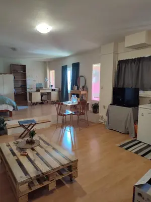 a large living room with a table and a couch at Lovely small apartment in Chania Town