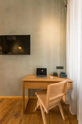 a wooden desk with a laptop on top of it at Full House in Chania Town