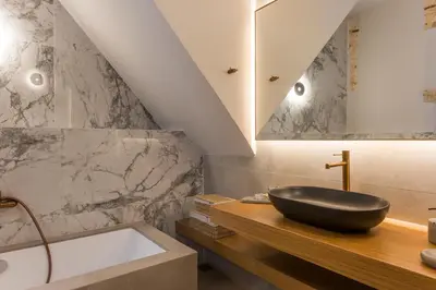 a bathroom with a black sink and a bath tub at Full House in Chania Town