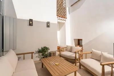 a living room with chairs and a table at Full House in Chania Town