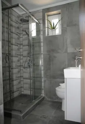 a bathroom with a shower and a toilet at Vaso's comfort apartment 1 in Chania Town