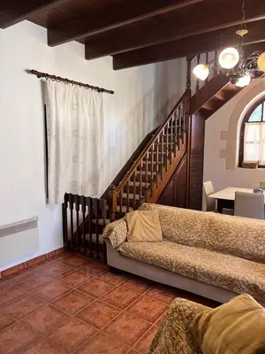 a living room with a couch and a table at Tzortzinas Cottage in Chania Town