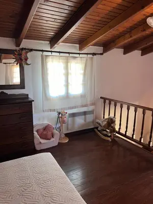 a bedroom with a bed and a window at Tzortzinas Cottage in Chania Town